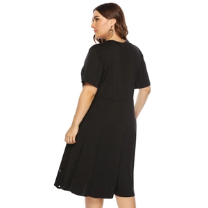 Back view of a plus-size black short sleeve dress with hollow dot hem details