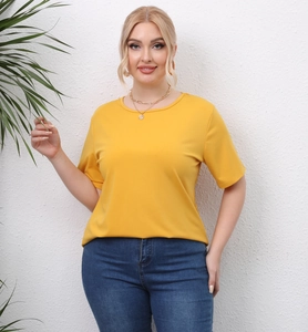 Detail of a bright yellow short sleeve T-shirt with cutout angel wings on blue jeans