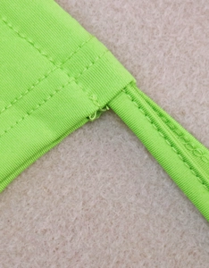 Detail of the neon green drawstring shoulder strap with reinforced double stitching