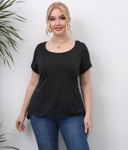 Detail of laser-cut floral hollow hem on a black plus size casual short sleeve T-shirt