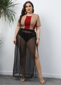 Detail view of contrast short sleeve top and black mesh sheer skirt with high side slit