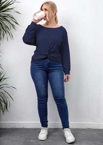 Detail view of navy blue long sleeve top featuring a unique front twist knot design