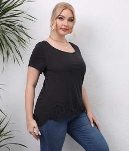 Close-up of black plus size T-shirt featuring laser-cut floral hem and U-neck detail