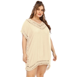 Detailed view of bohemian crochet hollow lace on a beige V-neck plus size beach cover-up