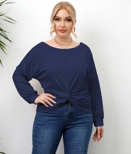 Detail shot of navy blue long sleeve top with irregular twist knot hem design