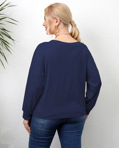 Detail view of navy blue long sleeve top with ribbed cuffs and soft fabric texture
