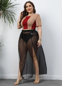Detail view of high waist elastic band on semi-sheer black mesh beach maxi skirt