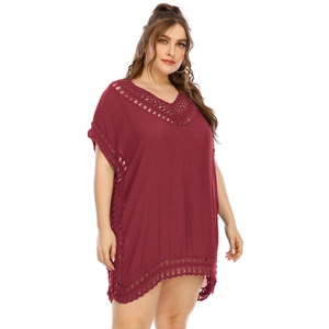Close-up of crochet V-neck detailing and hollow lace stitching on a burgundy beach dress