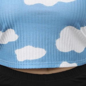 Close-up of sky blue ribbed knit fabric with white cloud pattern on short crop top