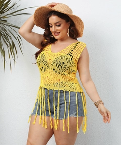 Detail of yellow plus size crochet beach cover-up featuring fringe hem and hollow patterns
