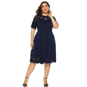 Detailed close-up showing the intricate laser-cut floral patterns on dark blue dress