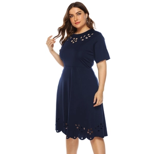 Detail of navy blue plus size dress showing laser cut floral hollow patterns on the hem