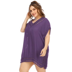 Close-up of V-neck crochet lace detailing and fringe on the purple beach cover-up dress