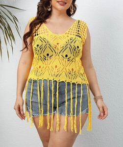 Detail of yellow crochet plus size beach cover-up with hollow patterns and long tassels