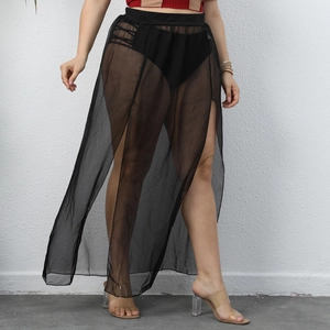 Detailed close-up of sheer black mesh fabric with high side slit on beach skirt