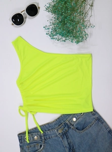 Detail of neon green one-shoulder crop top with adjustable side drawstring ruching