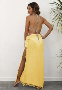 Detail of yellow beach sarong wrap featuring side tie and elegant fringe tassel trim