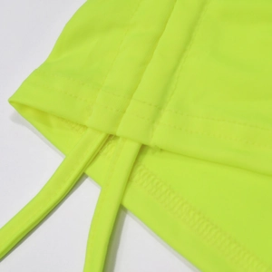 Detailed macro view of neon yellow knitted fabric with neat double stitching and tie straps