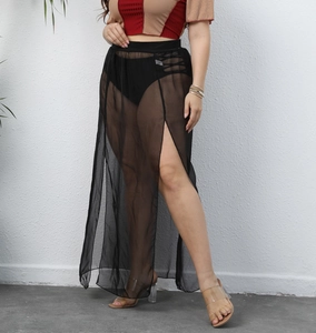 Detail of high side slit and sheer mesh fabric texture on this black beach cover-up skirt