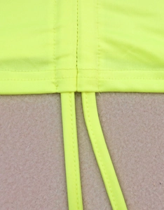 Detail view of neon green drawstring ties and ribbed texture on cropped shoulder top