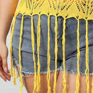 Yellow hollow crochet tassel top paired with classic blue denim shorts for summer beachwear