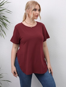 Detail of plus size wine red T-shirt showing round neck and side split hem on a model