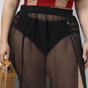 Detailed texture of sheer black mesh beach cover-up skirt with high side slit detail