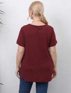 Detail view of the curved hem and long back of a deep red plus size short sleeve t-shirt