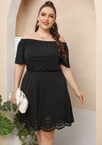 Detail of laser-cut floral pattern on the hem of a black plus size off-shoulder dress