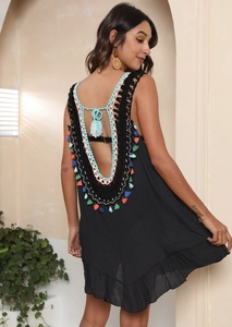 Detail of deep V backless crochet dress with multi-colored fringe and tiered knit layers