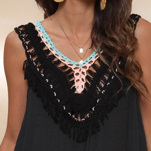 Detail of colorful crochet V-neckline with fringes on black summer bikini cover-up dress