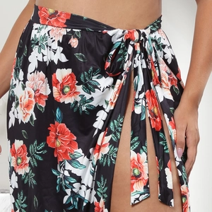 Detailed view of women's floral wrap skirt with side tie and elegant high slit design