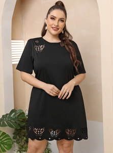 Detail showing laser-cut butterfly cutouts on a black plus size short sleeve dress