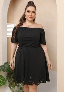 Detail shot of the black off-shoulder neckline and elastic waist on the plus-size dress