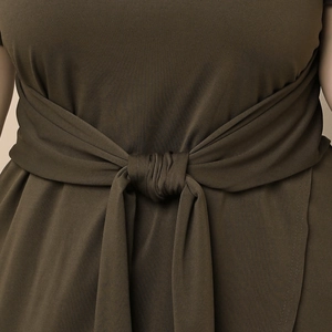 Close-up of olive green dress waist featuring a silky fabric tie-up belt detail
