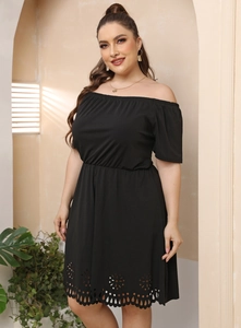 Close-up of laser-cut floral hollow patterns on the hem of a black off-shoulder dress