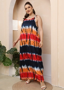 Detail of plus size maxi dress featuring vibrant tie-dye stripes and thin strap design