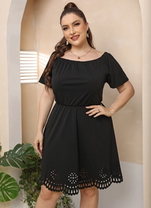 Detail of the laser-cut floral hem and elastic waist on this black plus size dress
