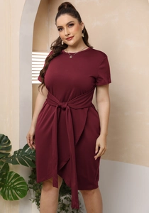 Detail view of burgundy plus size dress with lace-up waist and irregular hem design