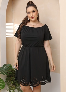 Detail of laser-cut floral hem on black off-shoulder plus size dress with elastic waist