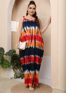 Detail view of colorful tie-dye stripes on a plus size maxi dress with spaghetti straps