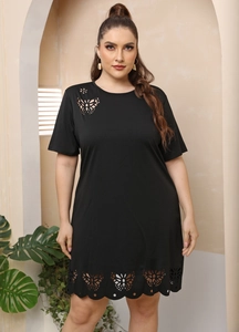 Detail showing laser-cut butterfly patterns on a black short sleeve A-line dress