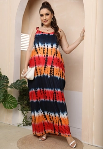Macro detail of the vibrant red and blue tie-dye pattern on the maxi summer dress