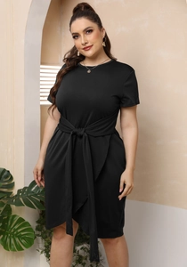 Detail view of plus size black dress showing waist tie-up knot and wrap skirt design