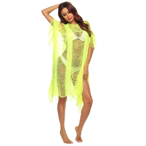 Detail of neon yellow knit beach cover-up with open-work design and long fringe hem