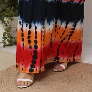 Detail of tie-dye floor-length maxi dress with vertical stripes and high-quality fabric