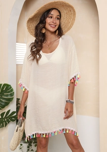 Detail of colorful tassel fringe on beige bohemian beach cover-up dress for summer vacation