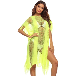 Detail view of the neon green crochet knit texture and fringe hem on the beach cover-up