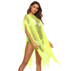 Detail of neon yellow knit beach cover-up featuring long tassel fringe and hollow-out design