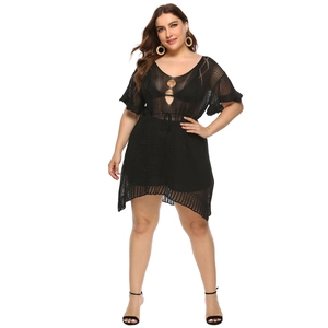 Detail of plus size black crochet beach cover-up featuring cut-out tie front design